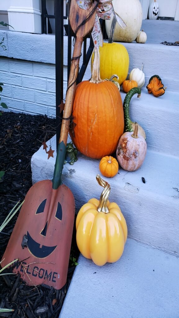 A Lit Pumpkin Cluster on the Steps Outperforms a Single Carved Pumpkin Every Time